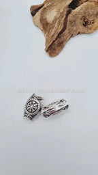 Two silver-toned Afro hair beads for locs or braids with intricate designs on white background