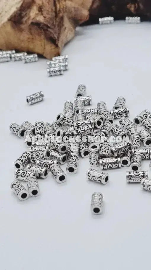 Silver afro hair beads with engraved patterns for braids and locks on white background