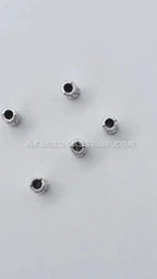 Five silver hair beads for locks or braids on a plain white background