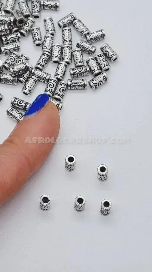 Decorative silver hair beads for locs or braids displayed on white background