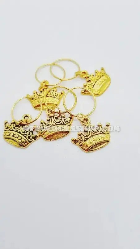 Set of gold crown-shaped hair accessories for locks and curly hair on white background