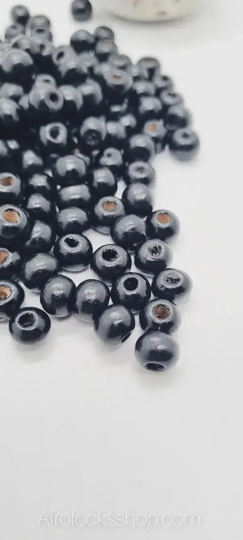 Glossy black wooden beads for locks and hair accessories on white background