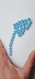 Blue wooden hair beads arranged on white background, ideal for locks and braids accessories
