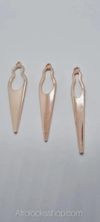 Three gold-tone metal African woman silhouette pendants for handmade afro jewelry on white background