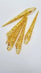 Set of ornate gold filigree hair cuffs for braids, dreads or locs on white background