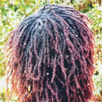 Microlocks hairstyle adorned with small zinc hair beads, afro textured hair accessories