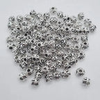 Silver zinc beads 6mm with 2mm hole, set of 100, for microlocks and braids on white background.