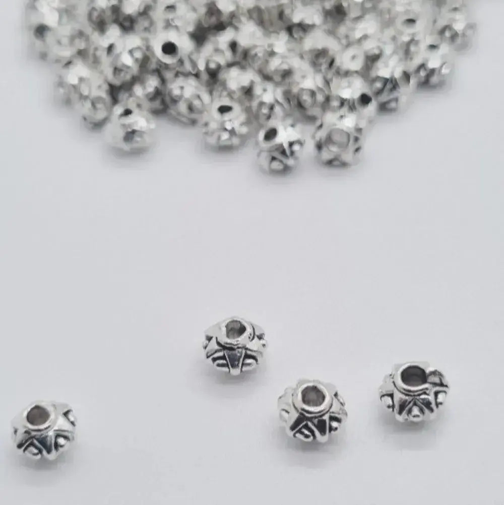 Silver zinc beads 6mm for braids, microlocks, and sisterlocks on white background