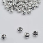 Silver zinc beads 6mm for braids, microlocks, and sisterlocks on white background